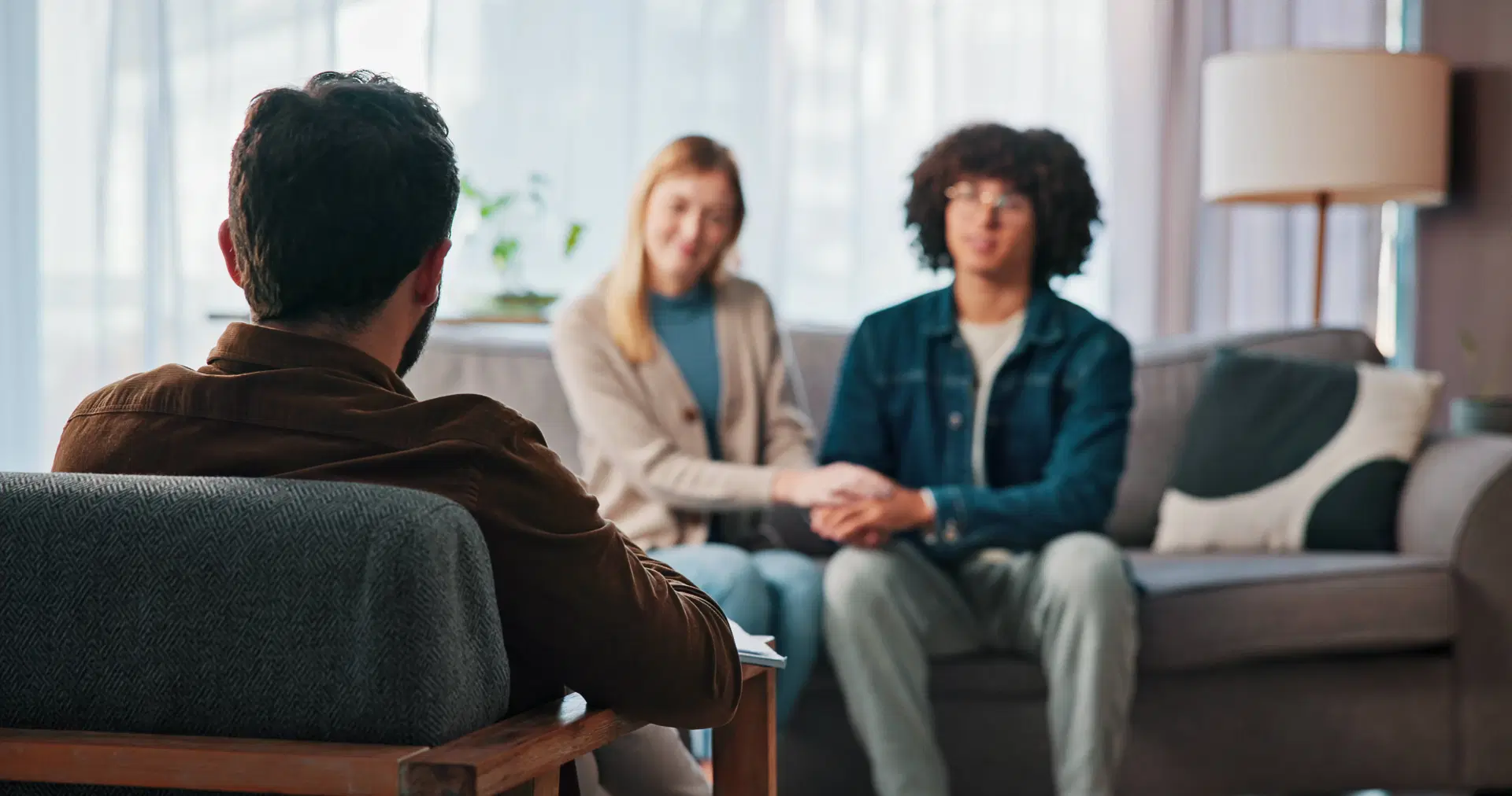 Couple holding hands during professional counseling